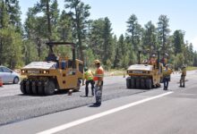 workers resurfacing a road with fresh asphalt