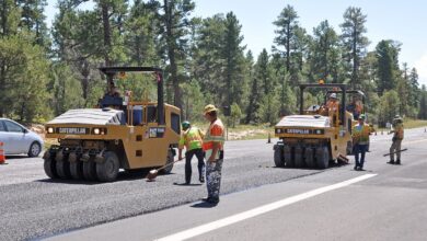 workers resurfacing a road with fresh asphalt