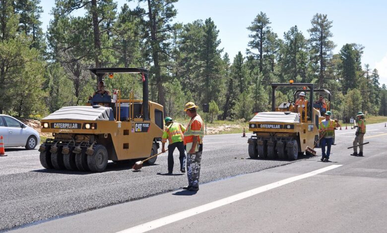 workers resurfacing a road with fresh asphalt